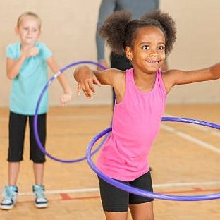 Children playing with hula hoops. 